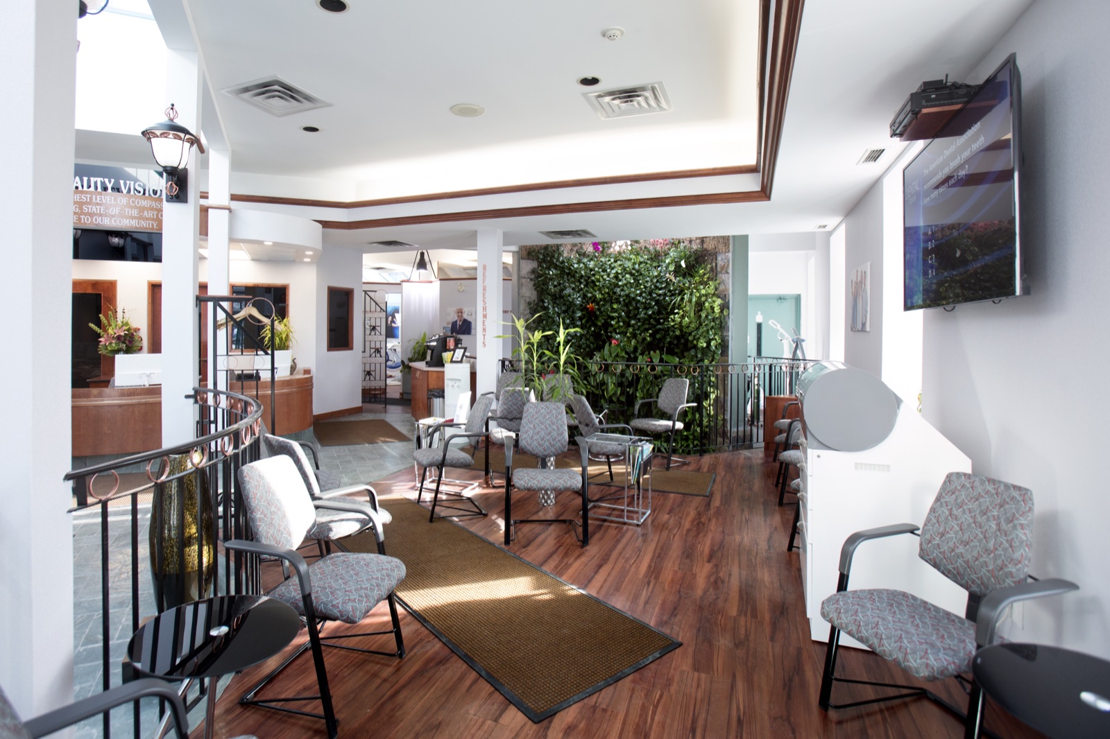 Our reception and waiting area, with the living plant wall at the centre of the practice