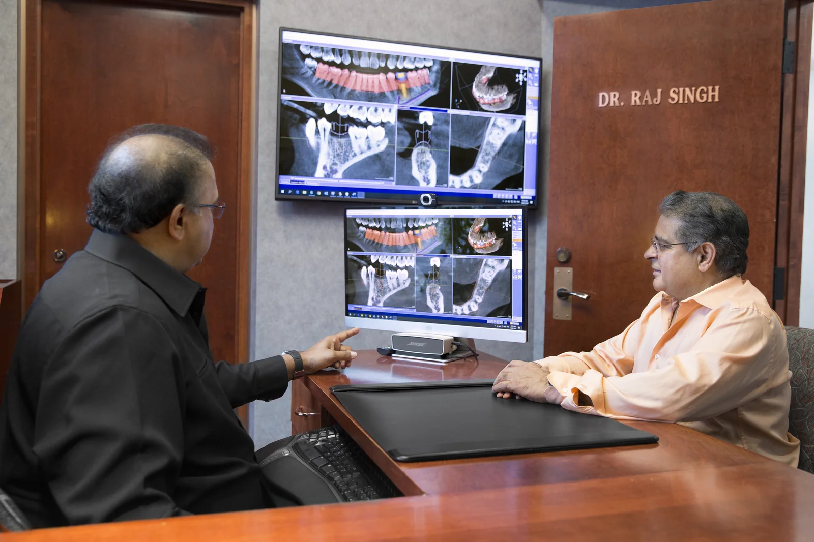 Patient reviewing 3D CBCT imaging on chairside display