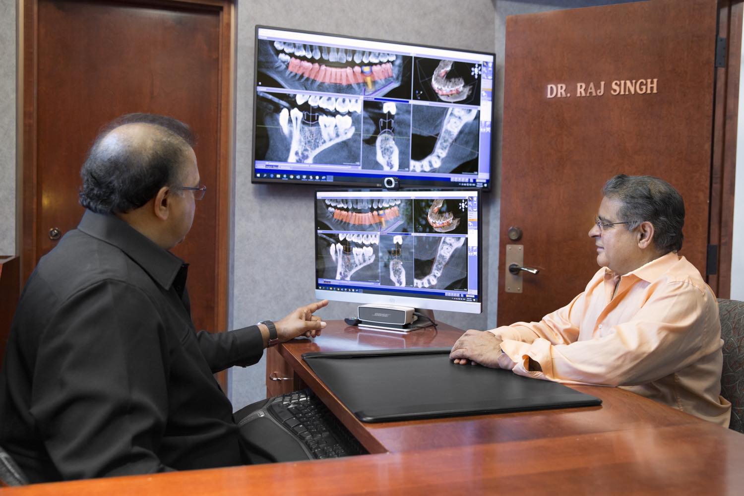 Dr. Raj Singh reviewing a patient's 3D scan with them at a consultation